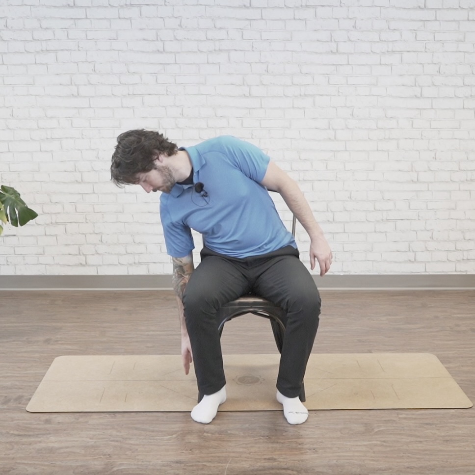 Seated side bend core exercise to the left