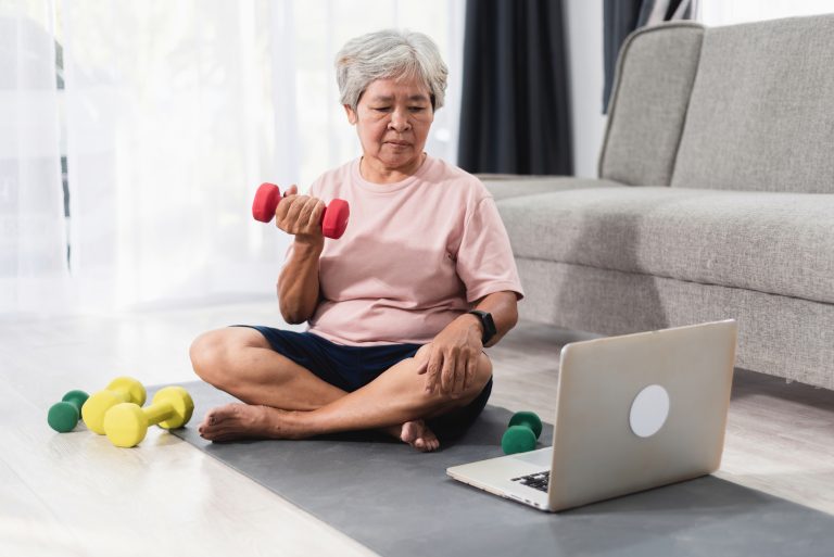 Senior woman getting fit with gentle dumbbell exercises